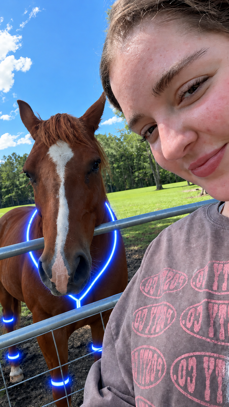 Rider selfie with a horse wearing glowing LED gear